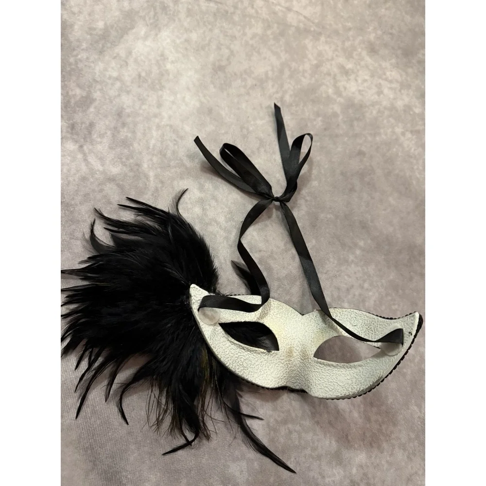modern, mass-produced plastic masquerade eye mask with black trim